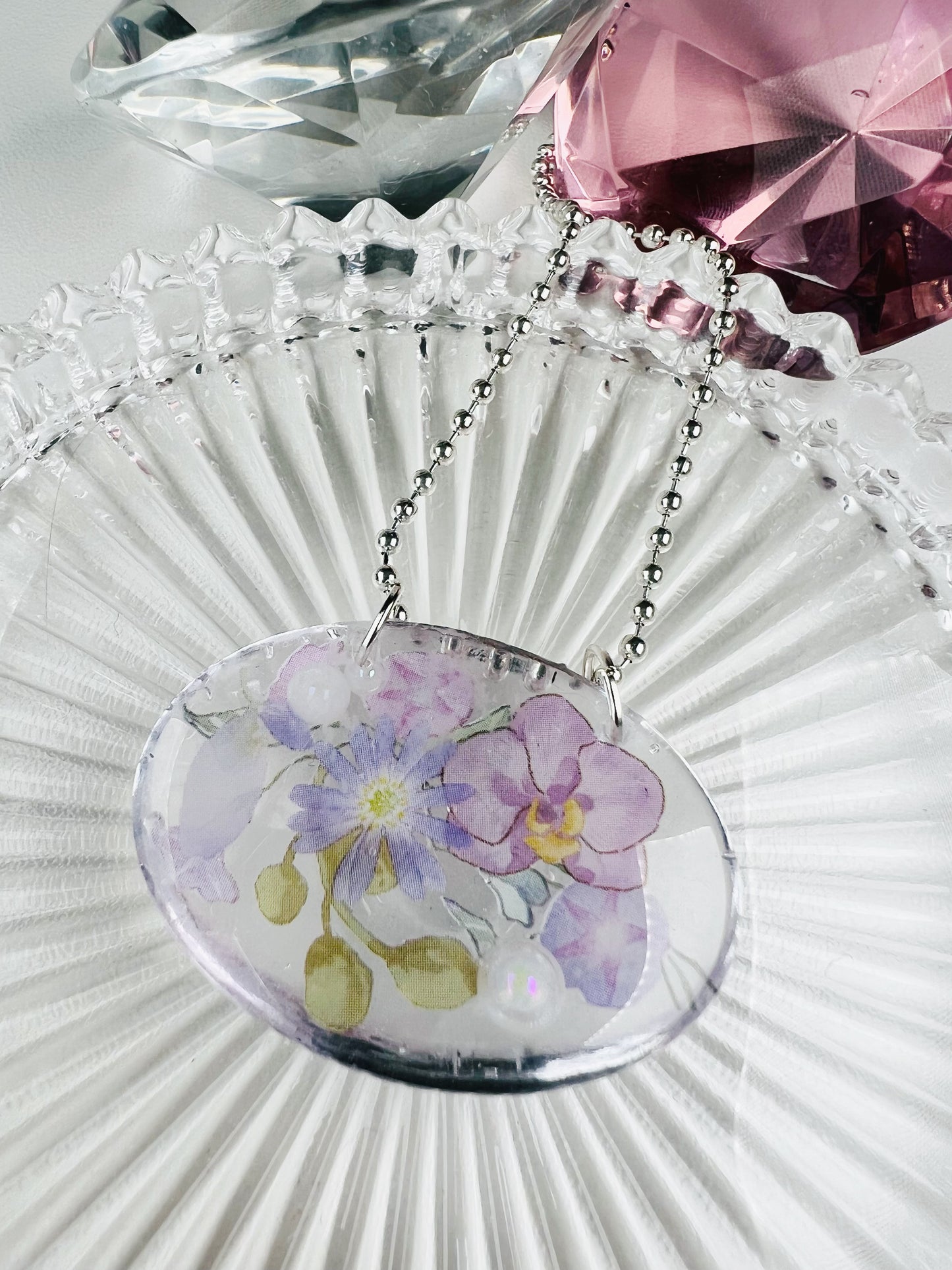 Purple flowers in oval necklace