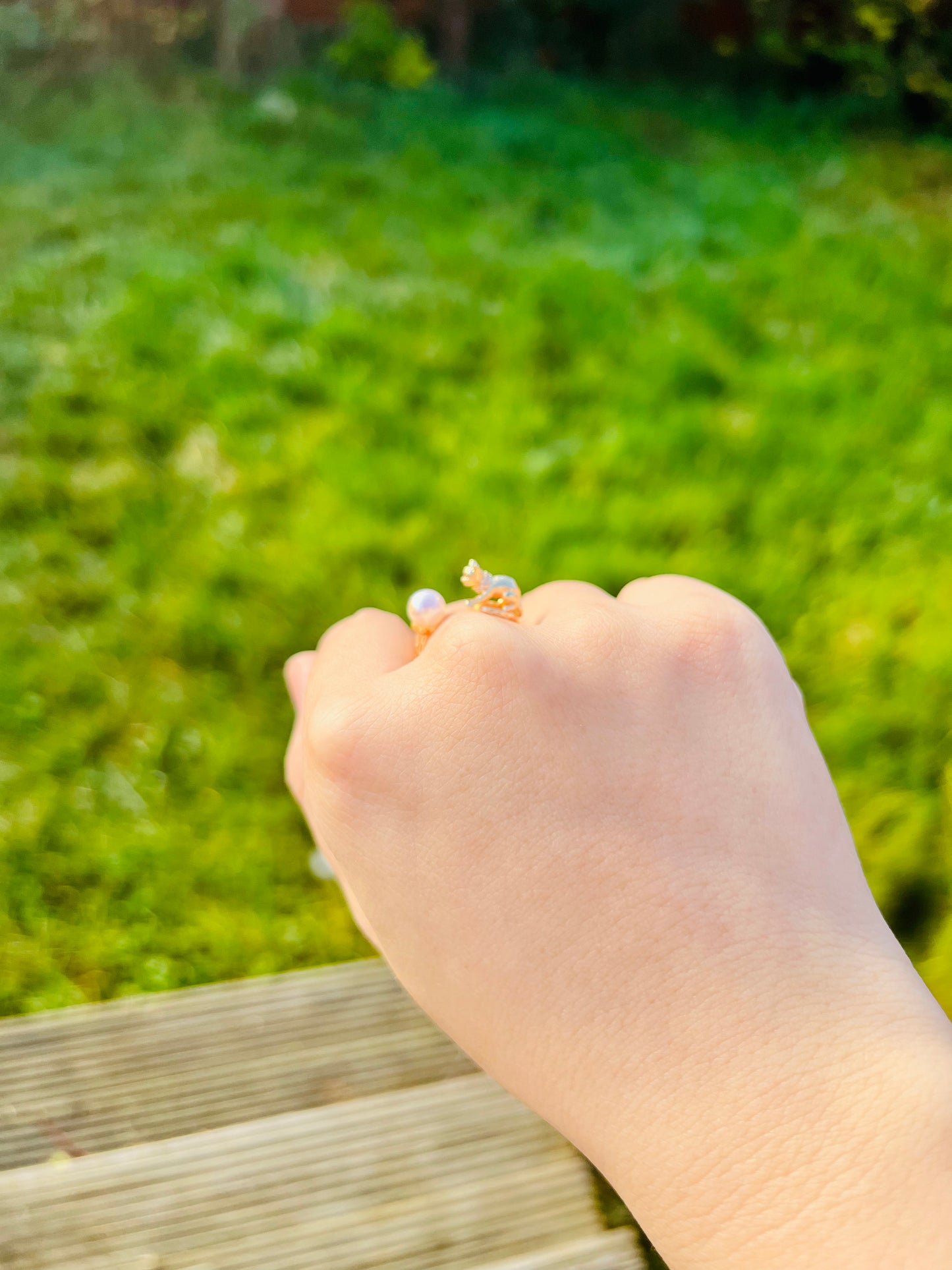 Cat playing with pearl ring