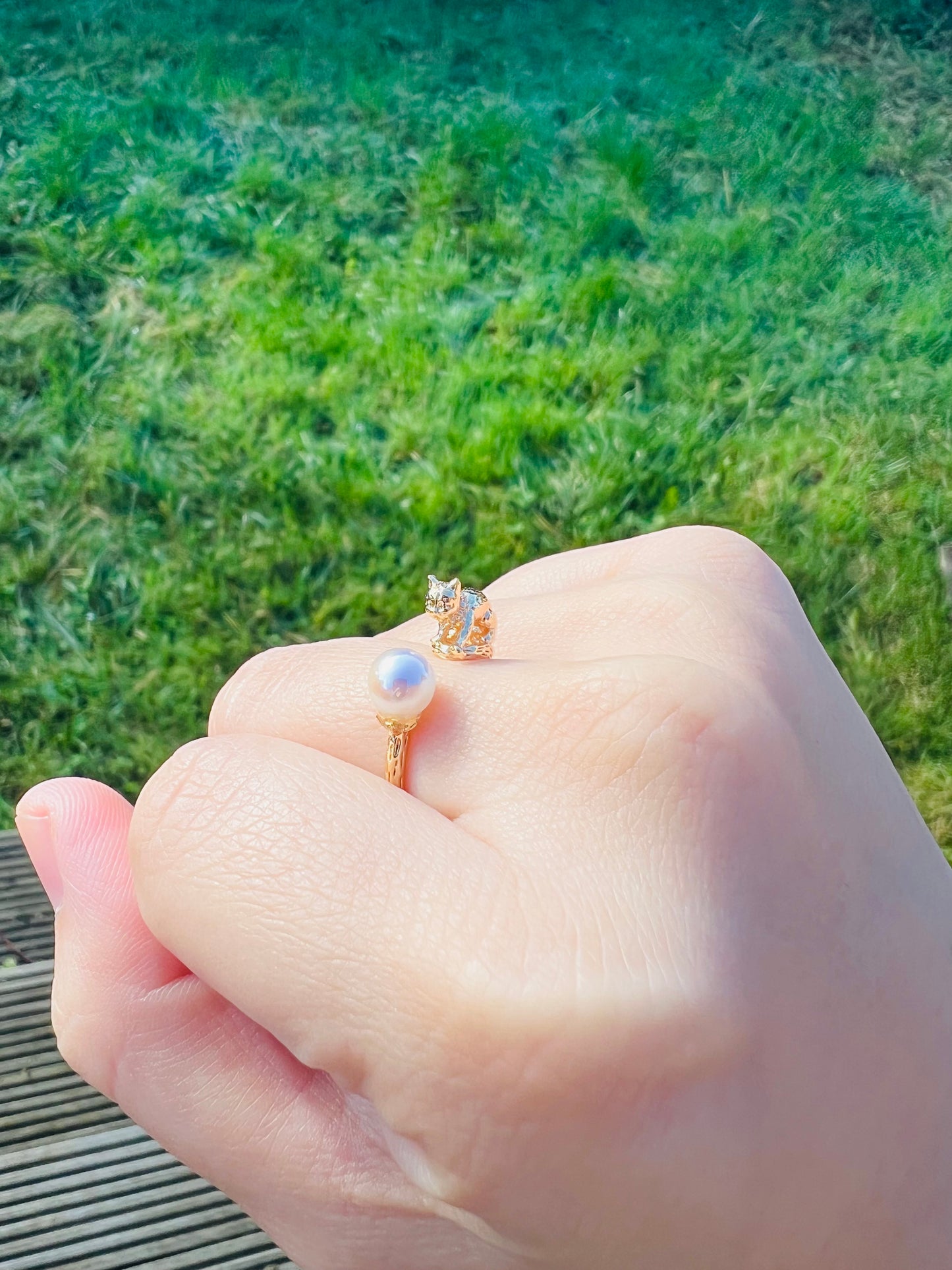 Cat playing with pearl ring