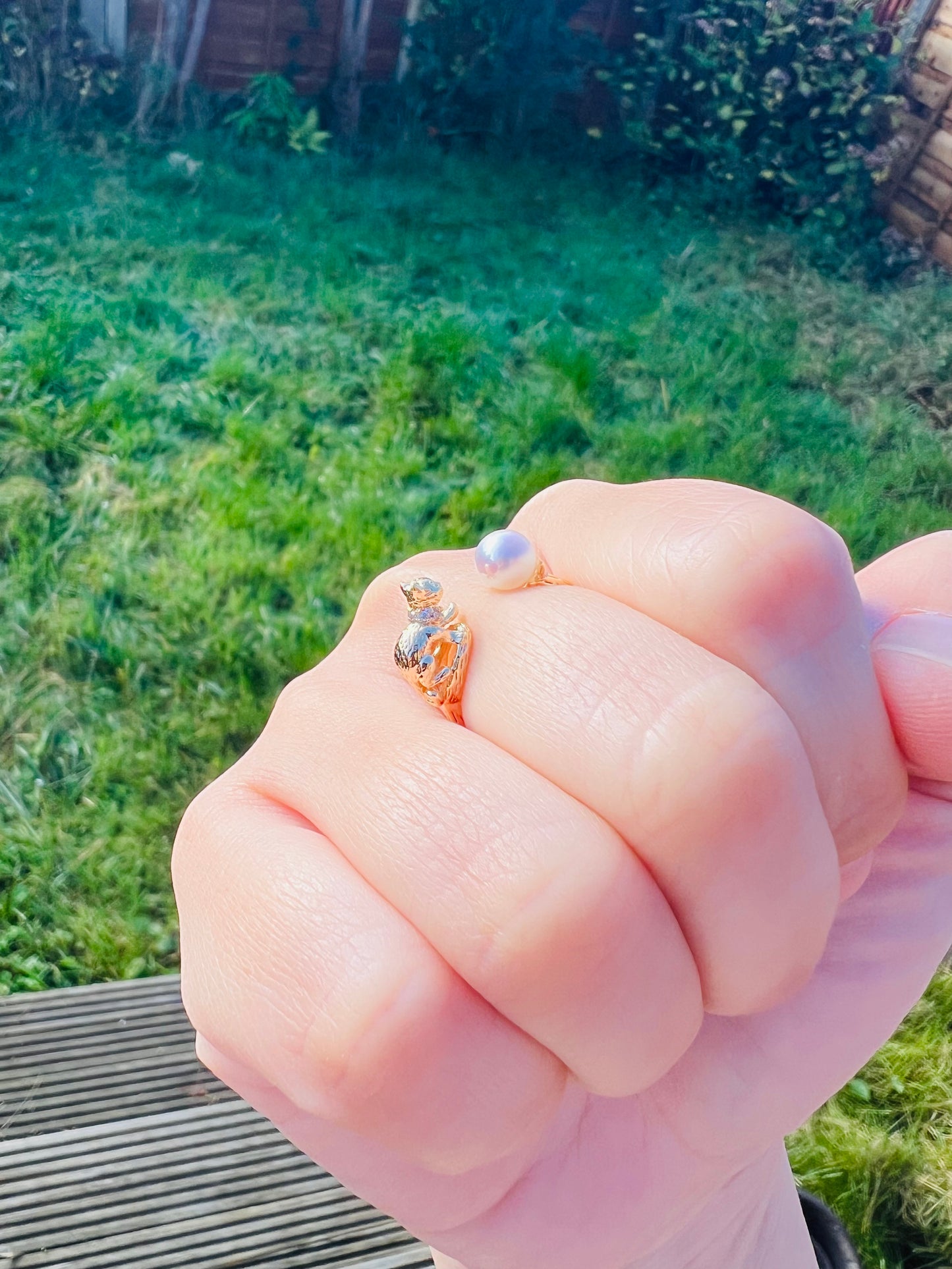 Cat playing with pearl ring